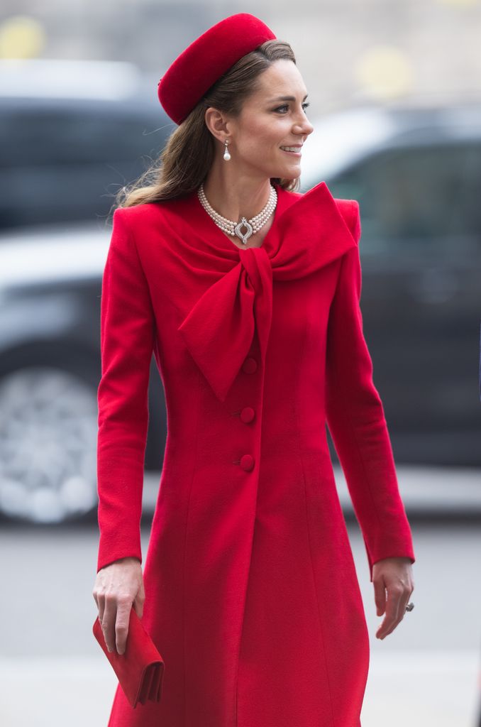 kate in red dress with bow on front 