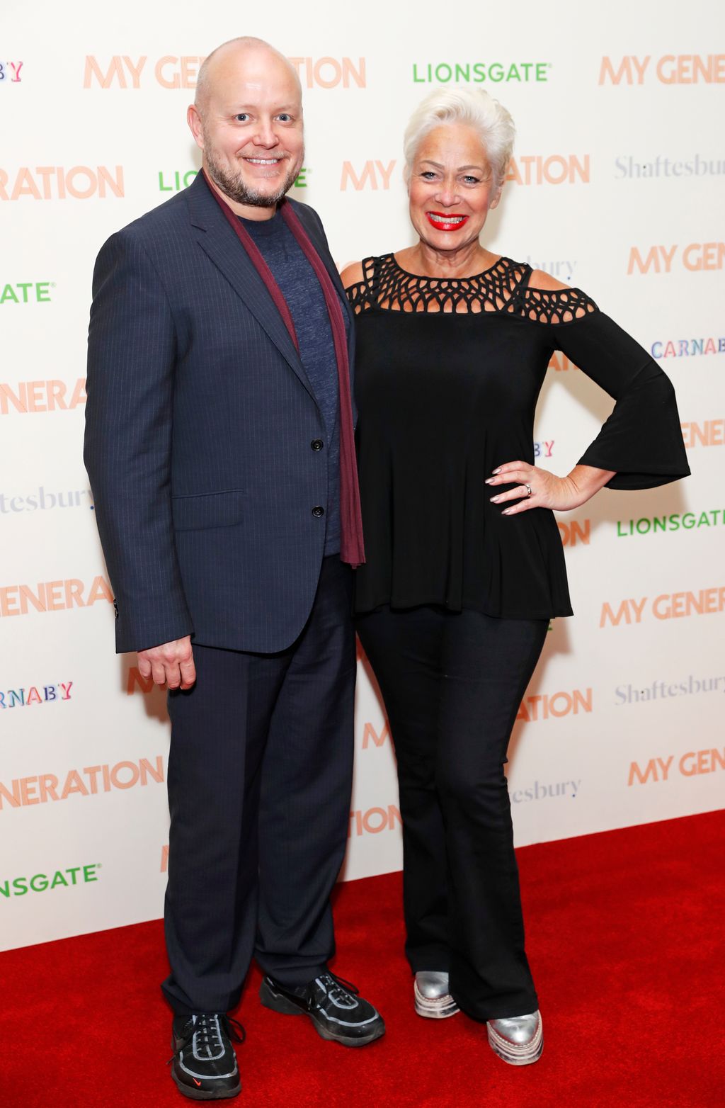 Lincoln Townley in a blue suit on the red carpet with Denise Welch in a black dress