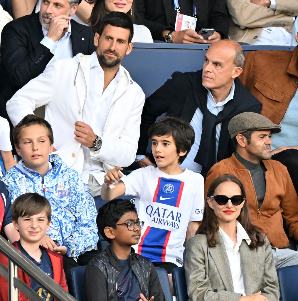 Serbian tennis player Novak Djokovic (3rd row Left), French actor Jamel Debbouze (2nd row Right) and US-Israeli actress Natalie Portman (1st row Center) attend during the French Ligue 1 (L1) soccer match between Paris Saint-Germain (PSG) and Clermont Foot