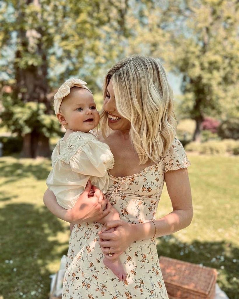 mollie king in garden holding daughter