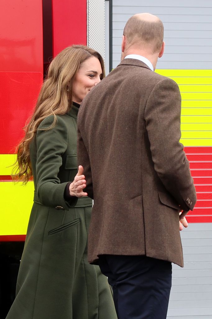 Kate touches William's back