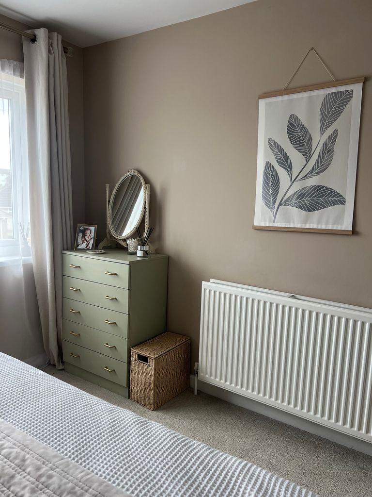 bedroom with radiator and chest of drawers