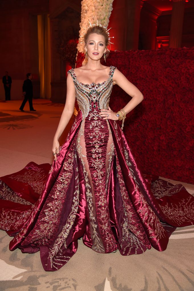 Blake Lively stunned in a bejewelled ruby Versace gown with gold embroidery and a halo crown at the 2018 Met Gala.