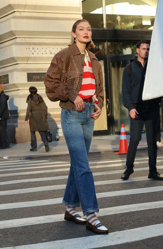 Gigi Hadid on street in jeans and striped jersey