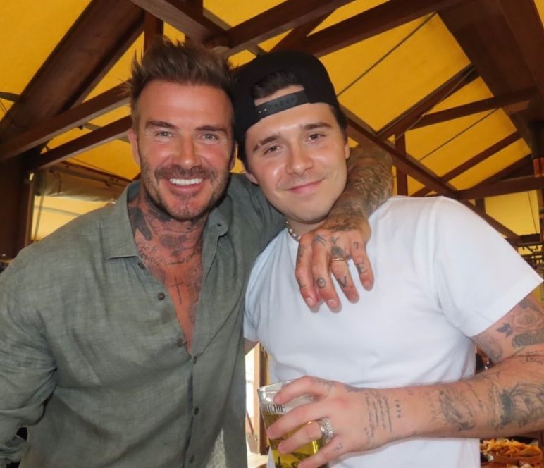 David Beckham with his arm around Brooklyn Beckham