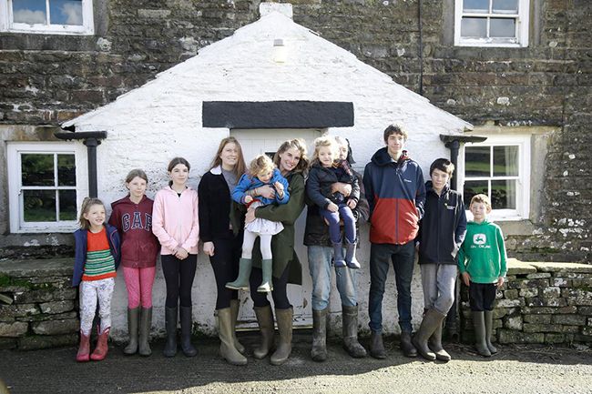 amanda owen family stand in front of house