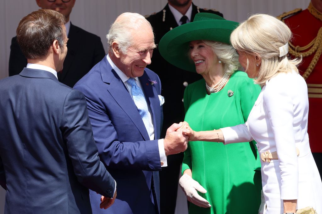 king shakes brigitte macrons hand beside emmanuel macron and queen camilla