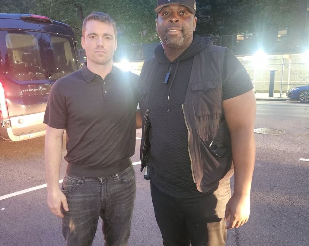 Gabriel Basso and a crew member on the set of season 3 of The Night Agent
