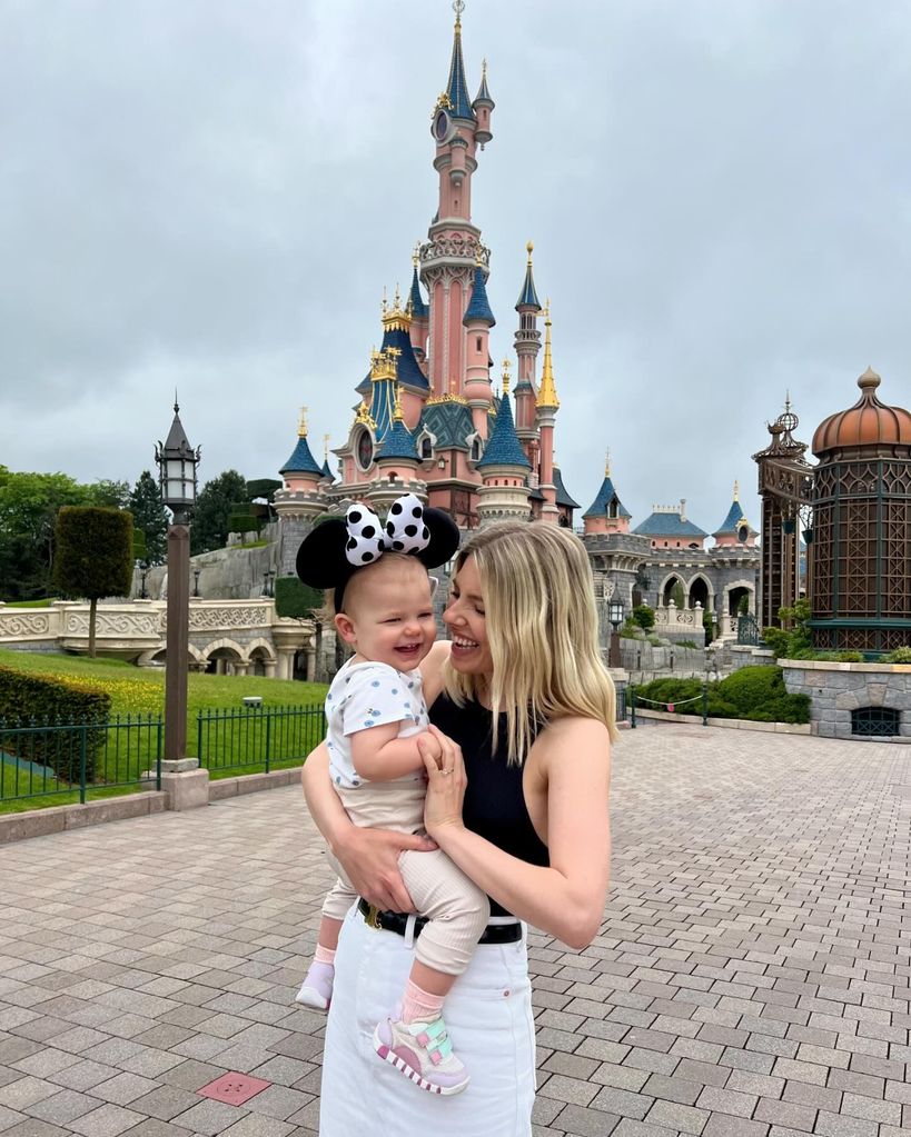 Mollie holding annabella at disneyland