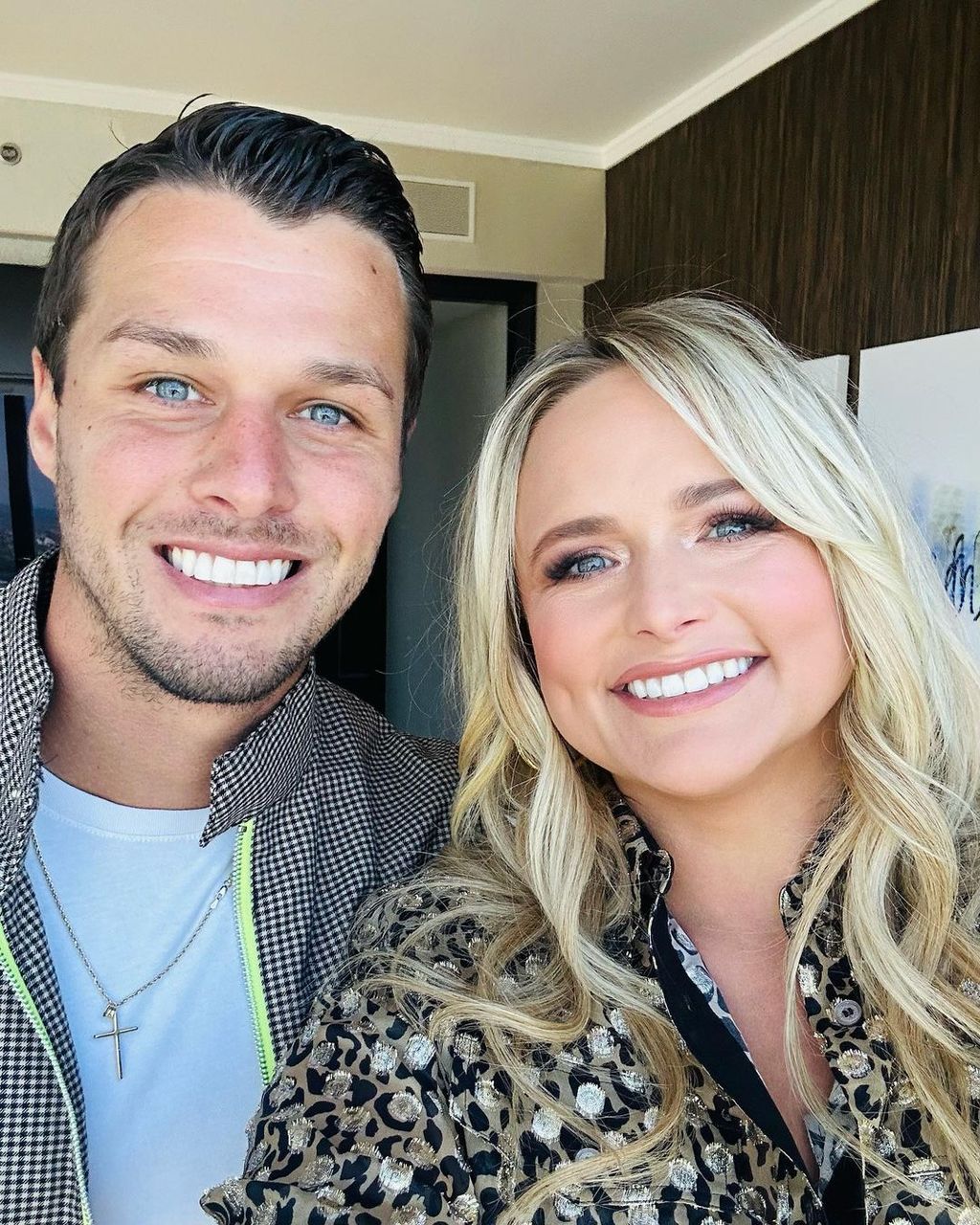 Miranda and Brendan smiling in a hotel room selfie