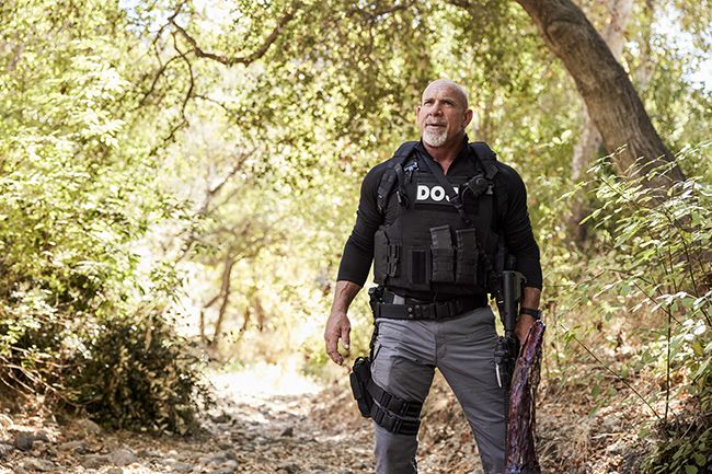 Lance Hamilton walks through woodland area on NCIS LA