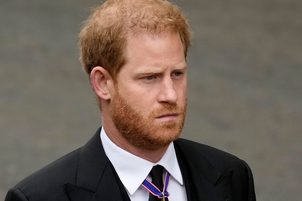 Prince Harry looking sombre in a black suit