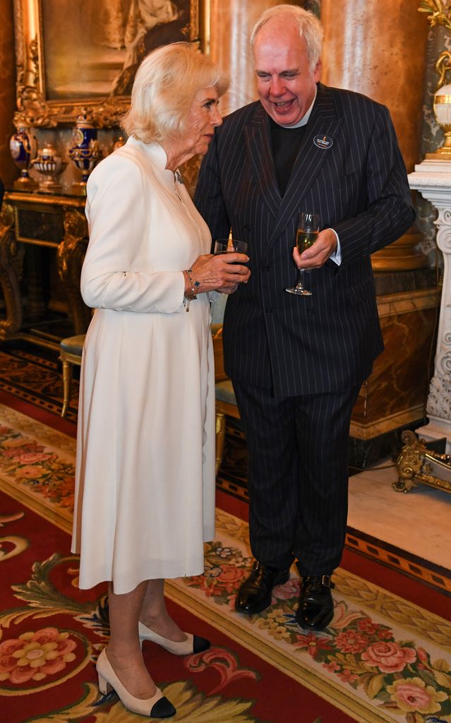 Queen Camilla talking to a man at Buckingham Palace
