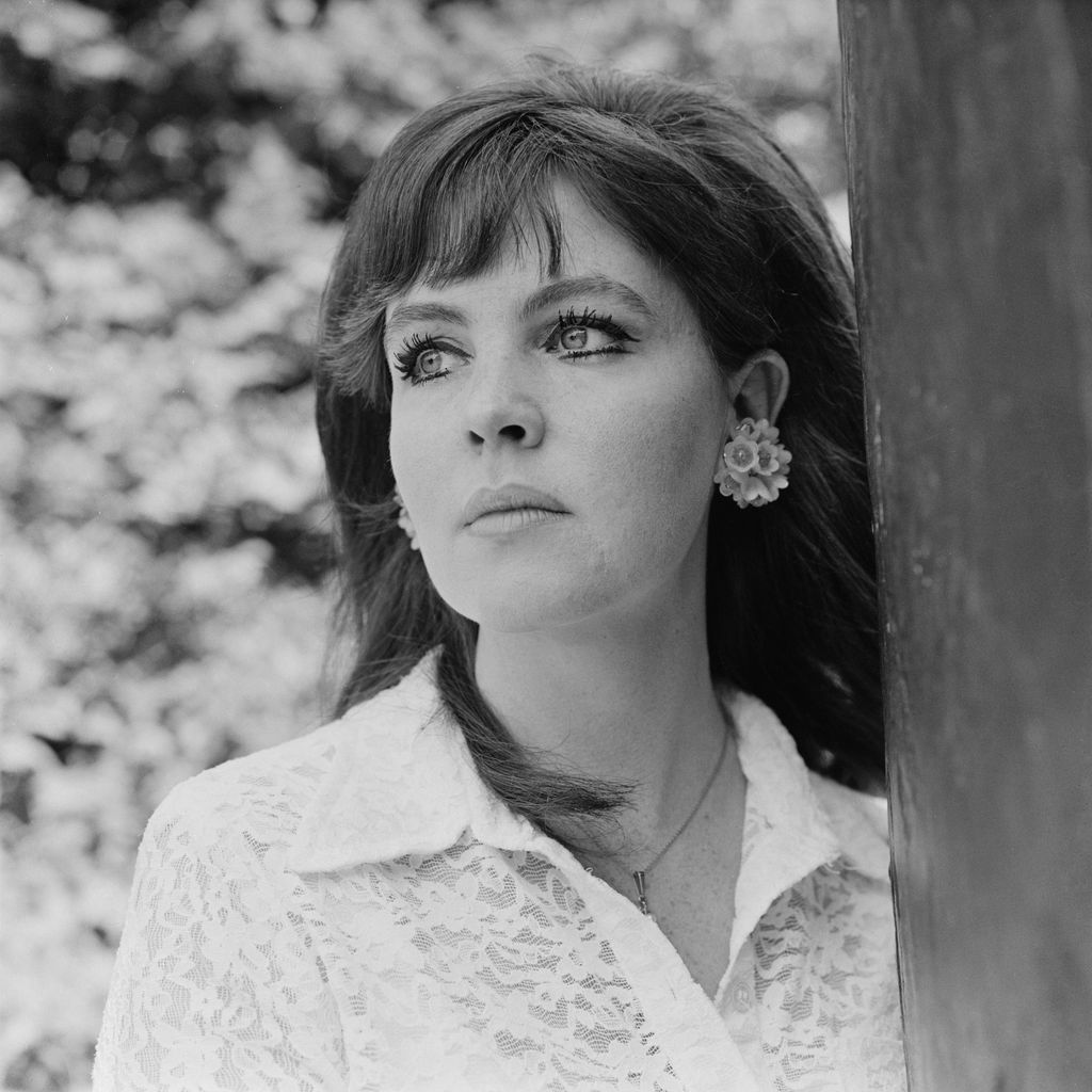 Pauline Collins pictured standing by a tree in a white shirt in 1969. 