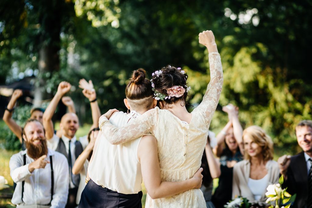 couple celebrating their marriage in front of their friends. 