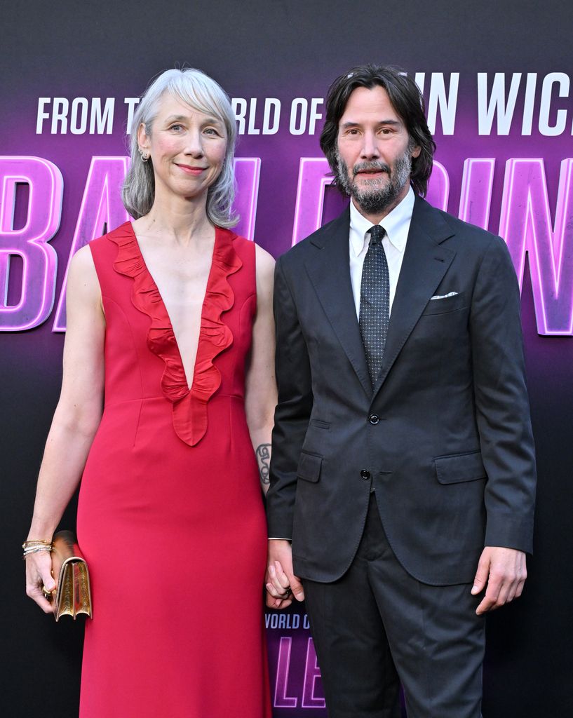 photo of keanu reeves and alexandra grant holding hands on red carpet