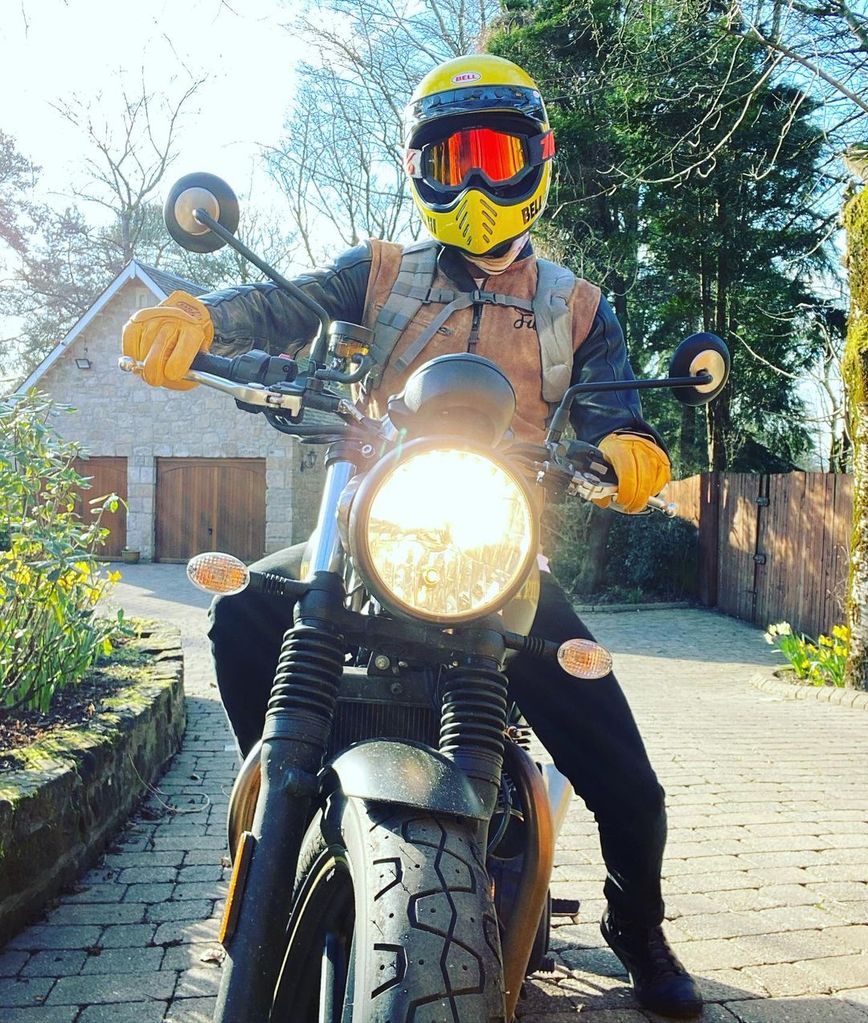Sam Heughan posed on a motorbike inside his driveway