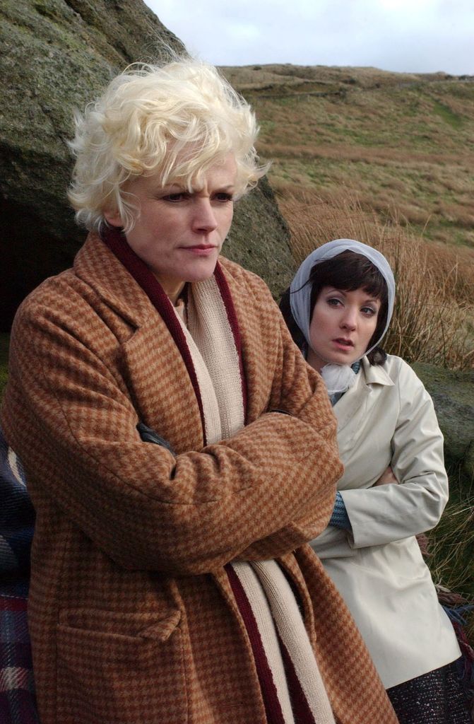 Woman with platinum blonde hair and brunette woman standing in moors