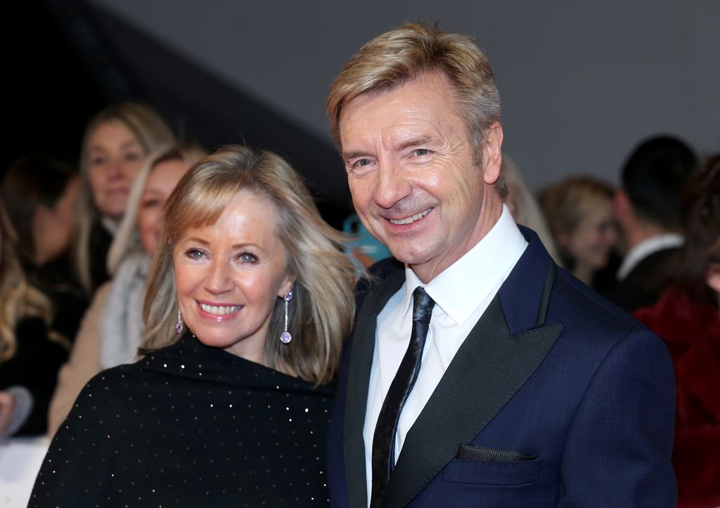 Karen Barber and Christopher Dean smile for photographers while attending the NTAs 