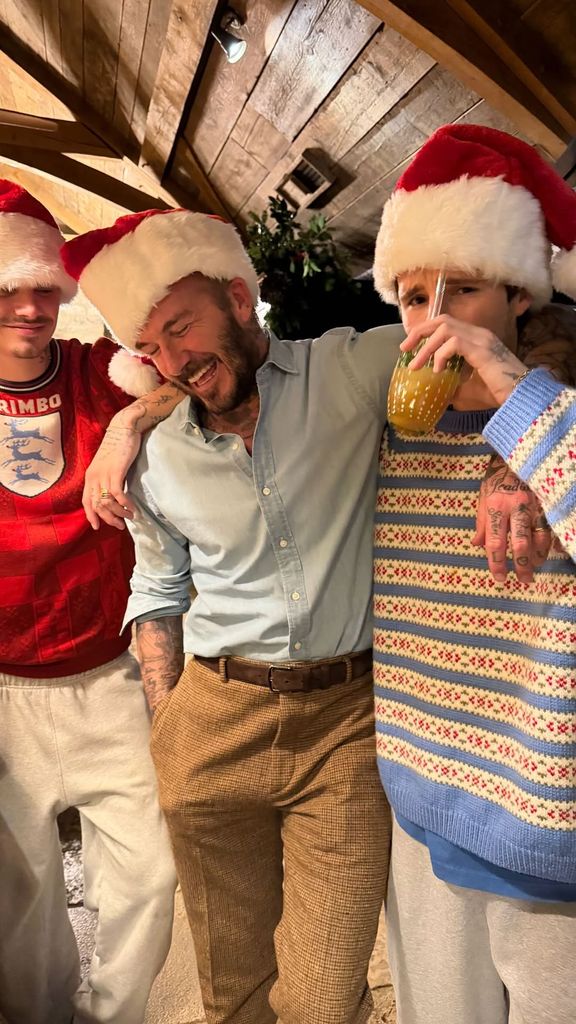Victoria shared a photograph of Romeo, David and Cruz having a fun moment together in matching Santa hats