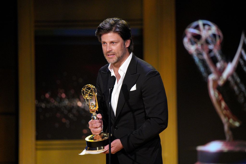 Greg accepts an award onstage during the 45th annual Daytime Emmy Awards 
