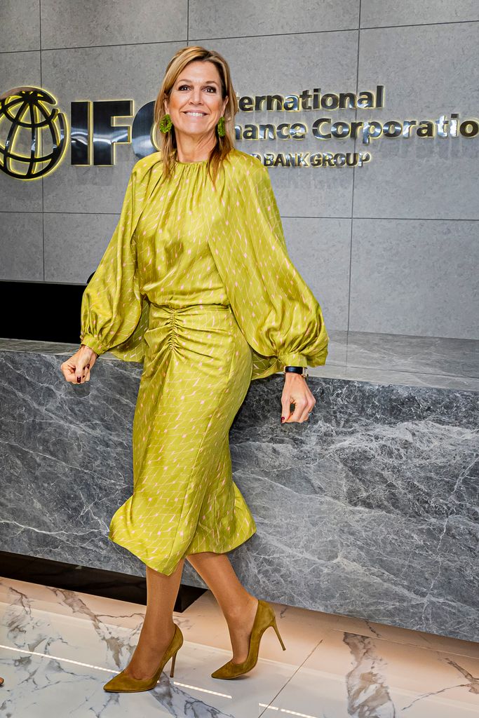 Queen Maxima in bank reception in lime green dress