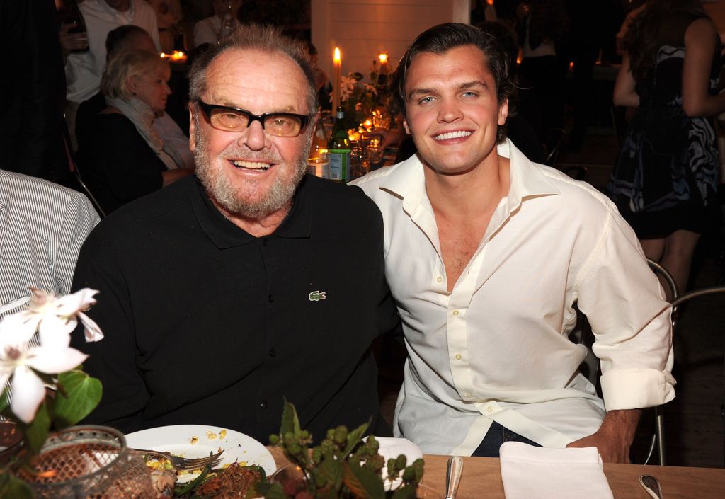 Jack and Ray Nicholson sat next to eachother smiling 