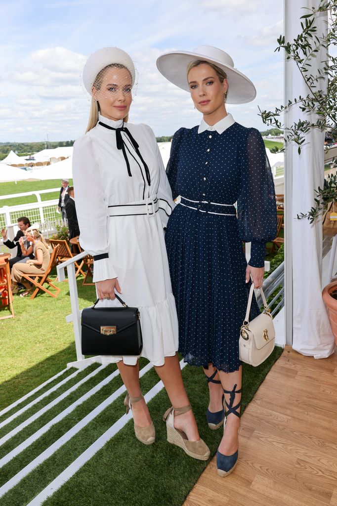 Lady Eliza Spencer and Lady Amelia Spencer in matching vintage-style navy and white dresses with belts and hats at Royal Ascot.
