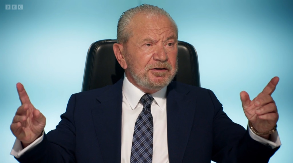 Man sitting in chair pointing his fingers