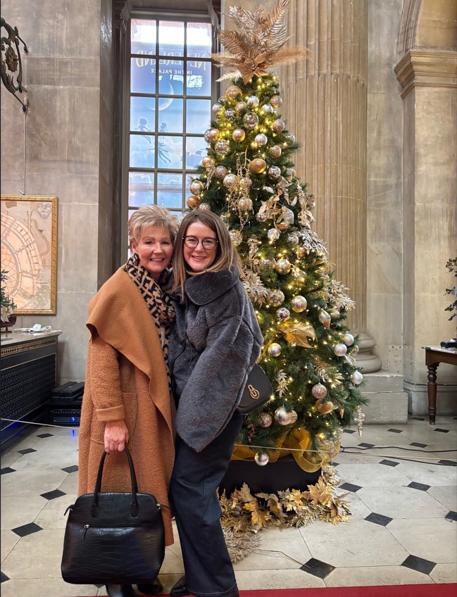 Lauren with mum in front of christmas tree