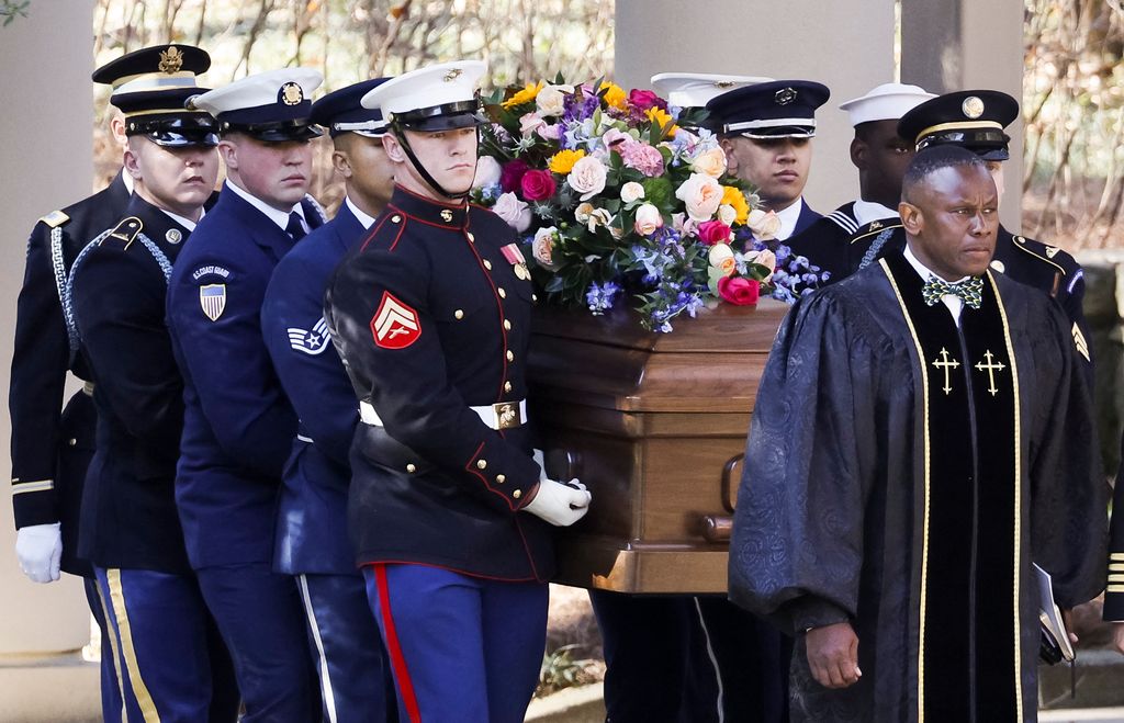 A military honor guard carries the casket of late US First Lady Rosalynn Carter from the Jimmy Carter Presidential Library and Museum in Atlanta, Georgia, on November 28, 2023, en route for an afternoon tribute service at Glenn Memorial Church at Emory University
