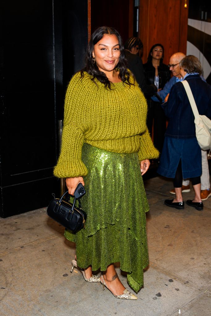 Paloma Elsesser in a shiny green skirt and chunky knit