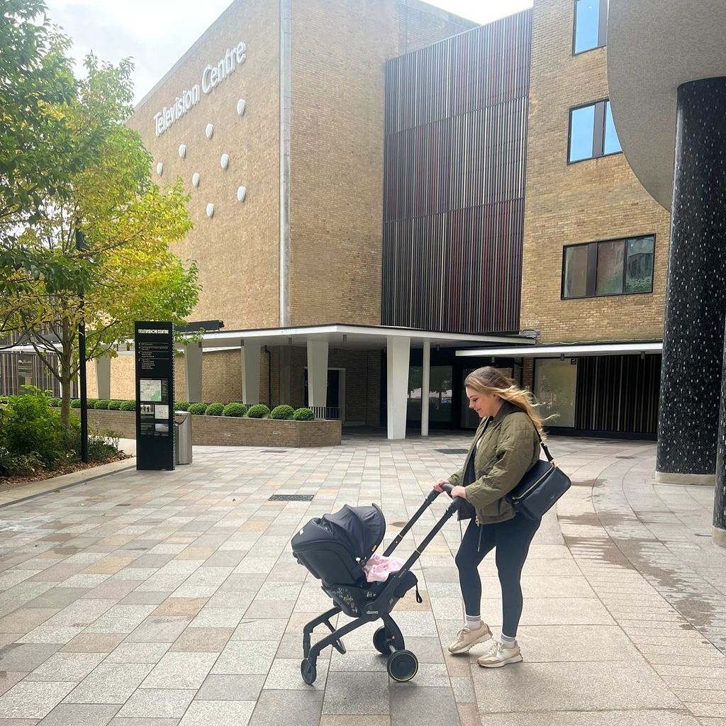 mother pusing daughter in pram