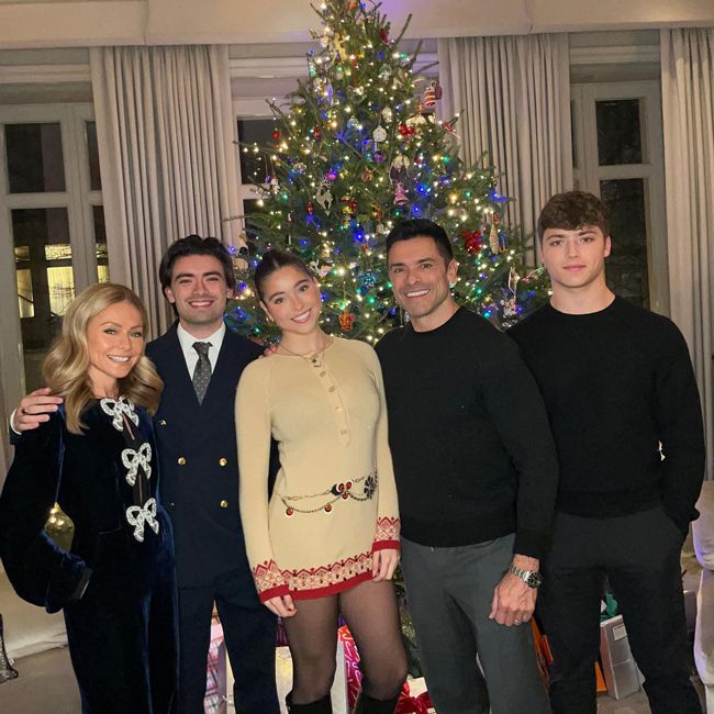 Kelly Ripa and her family in front of a Christmas tree