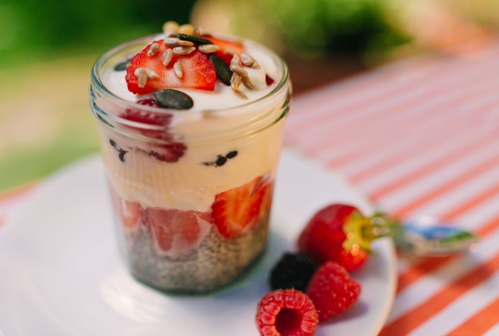 Fresh prepared glass of overnight oats with greek yogurt and strawberrys, raspberry and blueberry.