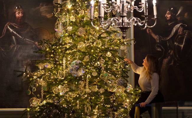 royal christmas tree with staff member adding baubles