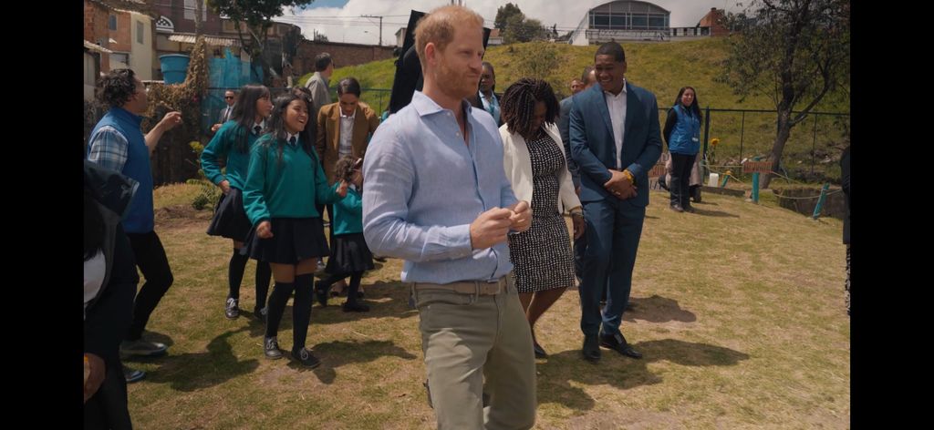 Prince Harry dancing with a group of students