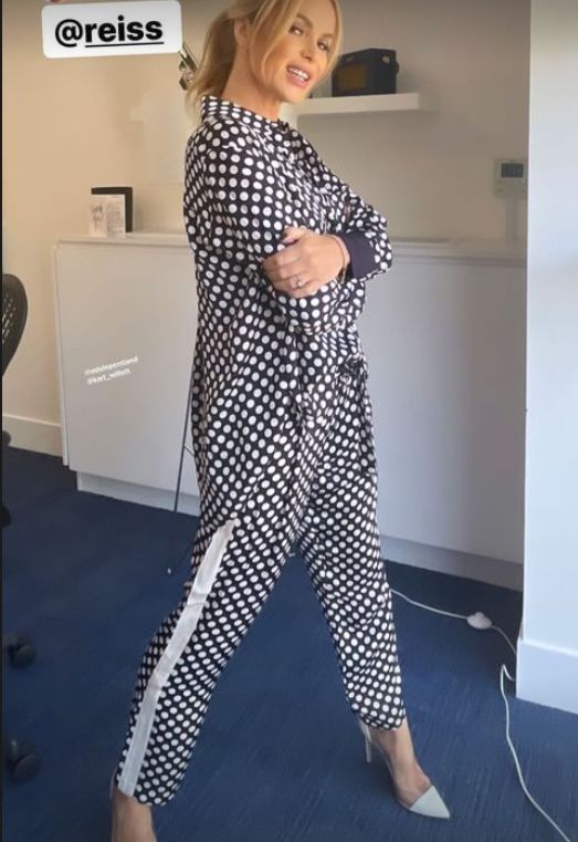 Amanda Holden posing in a polka dot outfit