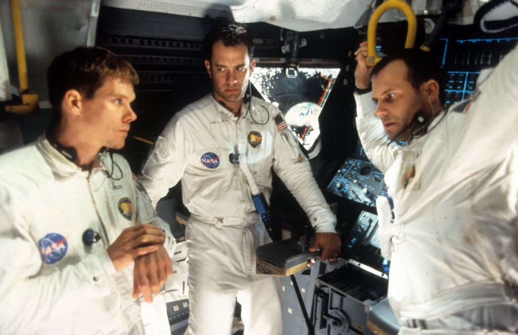 Kevin Bacon, Tom Hanks, and Bill Paxton talking in ship in a scene from the film Apollo 13
