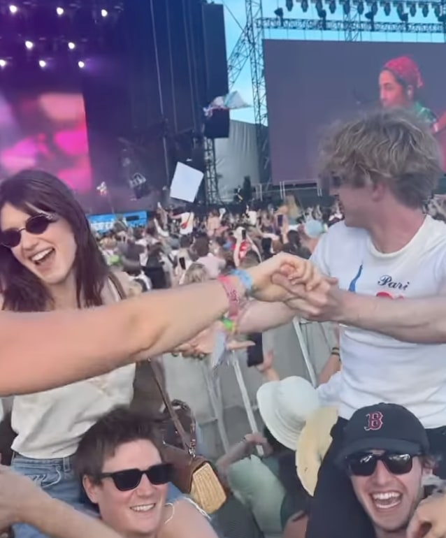 A photo of people in a crowd dancing 