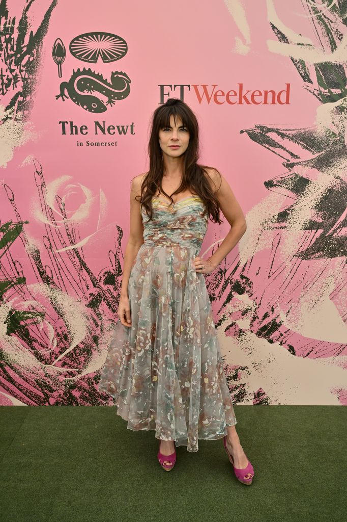 Martha Freud wears a strapless pastel floral tulle dress with hot pink peep-toe heels poses at FT Weekend x The Newt party at the Chelsea Flower Show