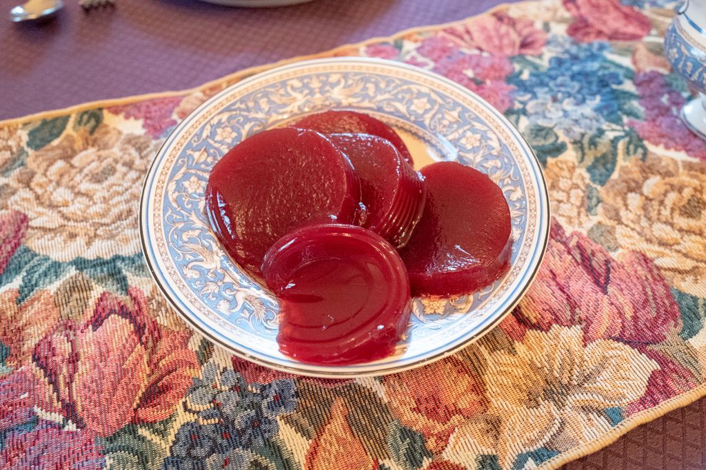 Table with elegant place settings and turkey motif during American Thanksgiving meal, with canned cranberry sauce visible, Lafayette, California, November 26, 2020. (Photo by Smith Collection/Gado/Getty Images)