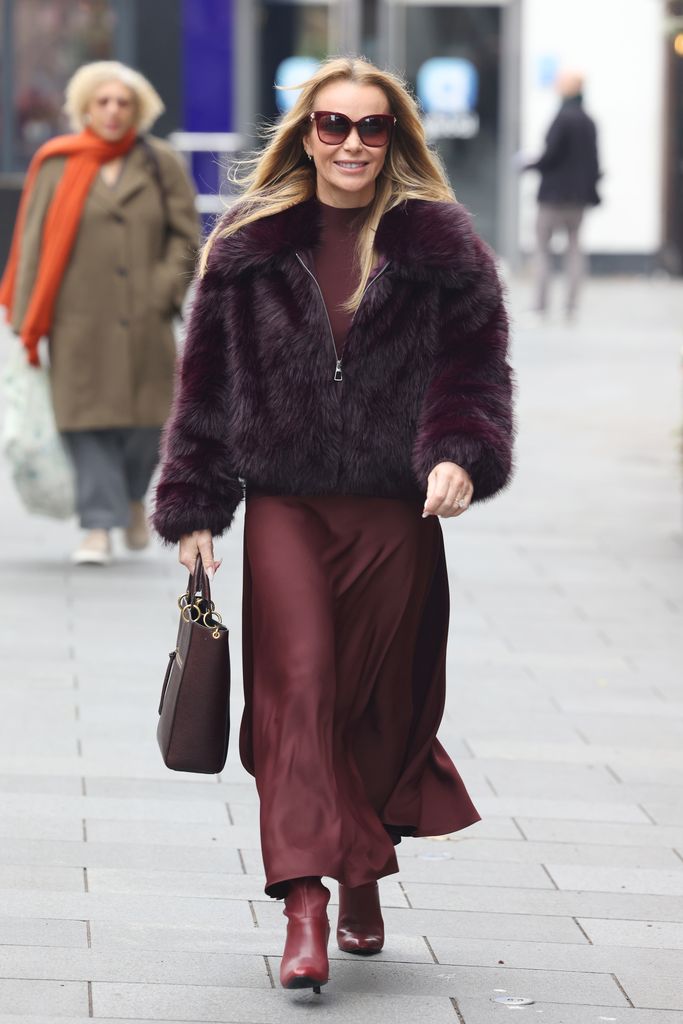 Amanda Holden in a silk skirt and fluffy jacket