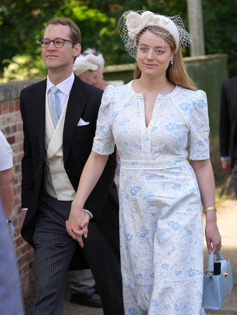 Timothy in suit and Flora Vesterberg in white and blue floral dress