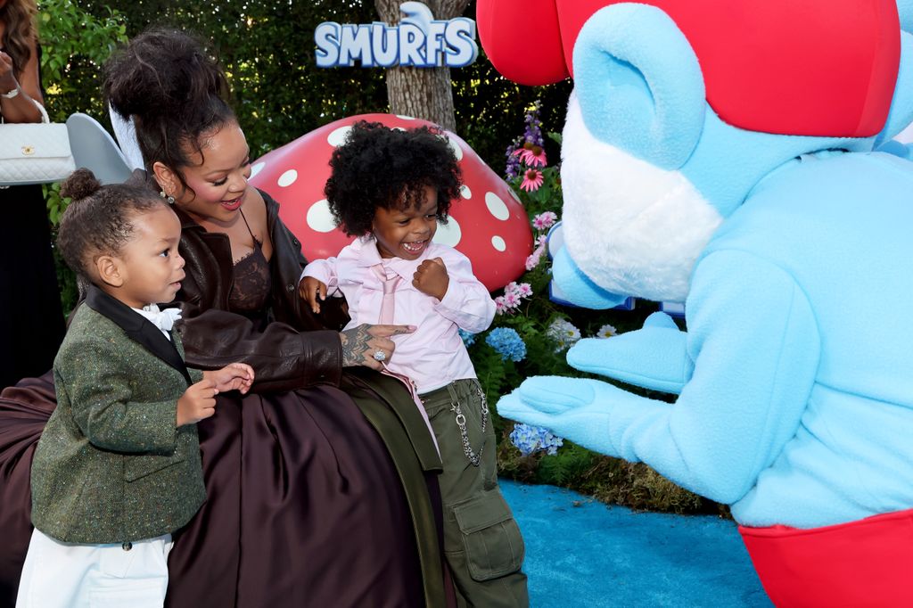 Riot Rose Mayers and RZA knelt with rihanna and smurfs figure