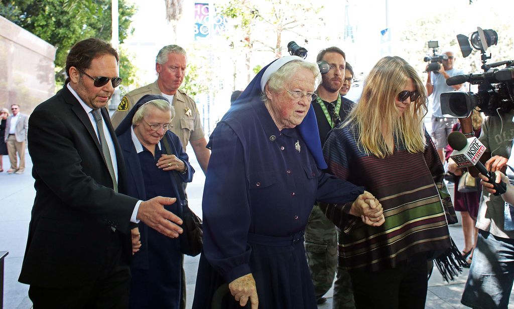 Sisters Catherine Rose Holzman and Rita Callanan, are escorted by businesswoman Dana Hollister,  out of Los Angeles Superior Court on Thursday, July 30, 2015
