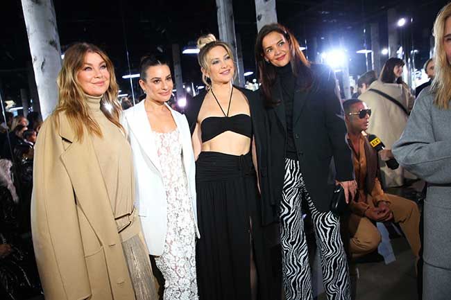 Kate Hudson posing with fashion show attendees 