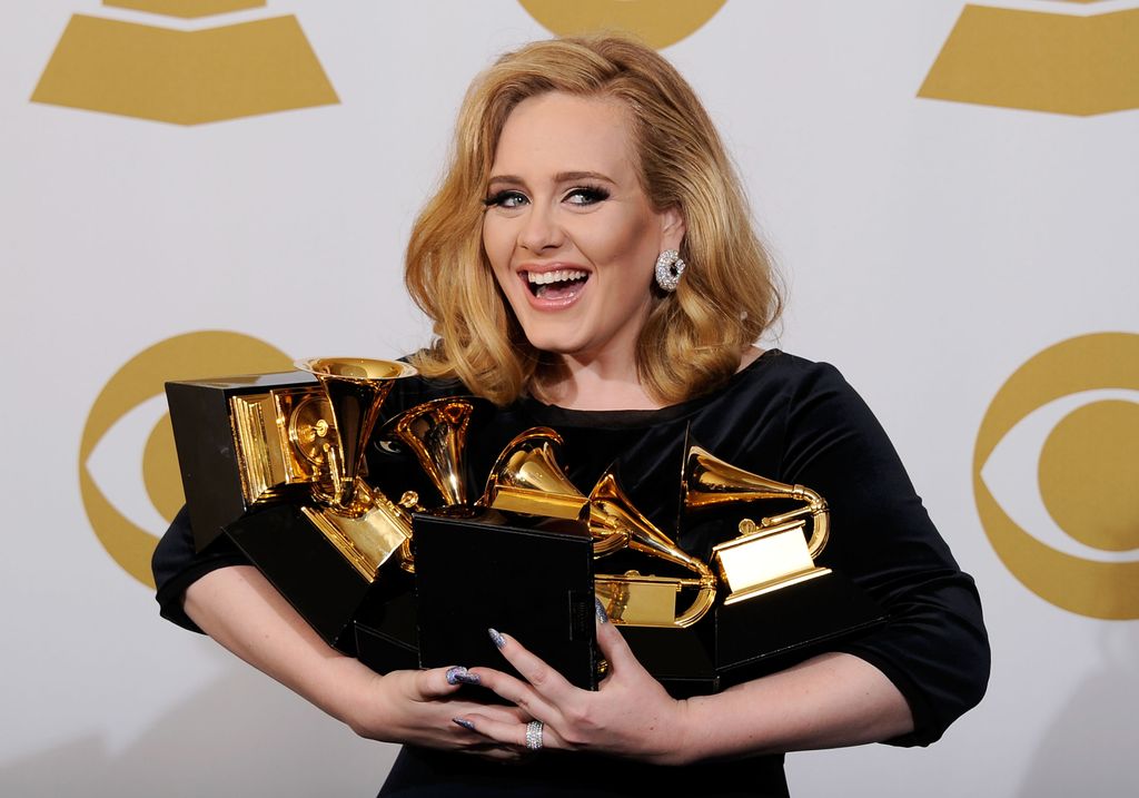 Adele wearing black dress with awards at grammys