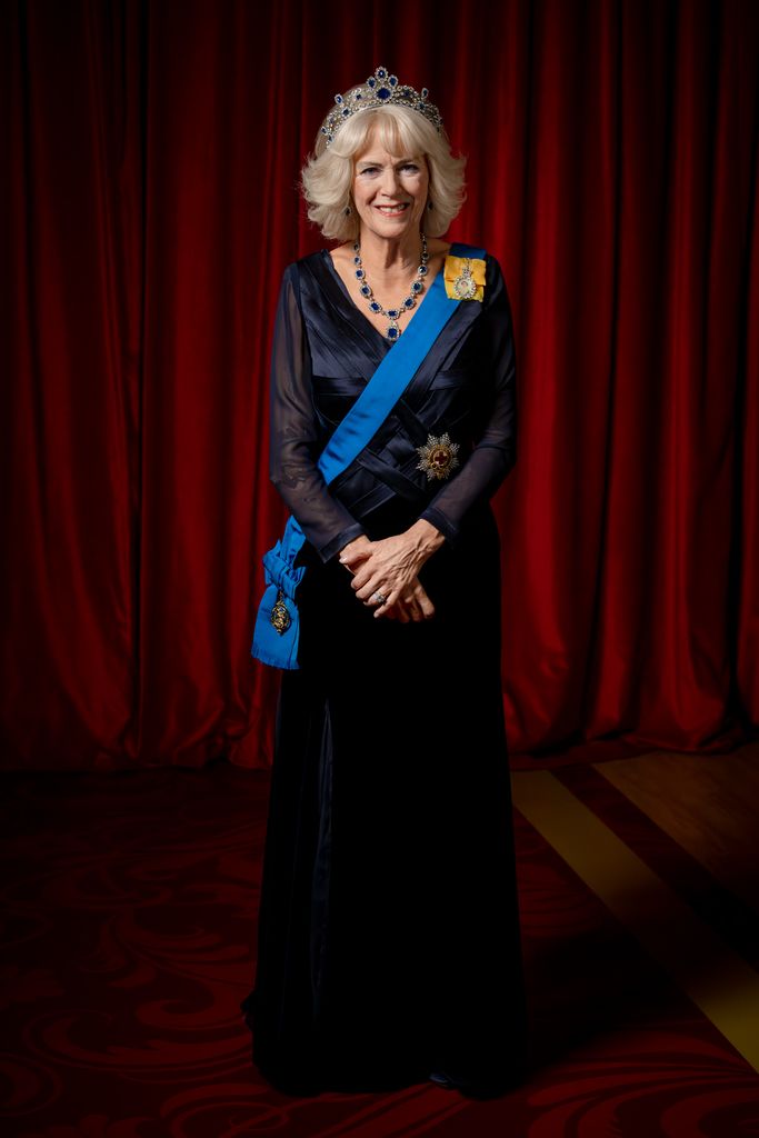 A waxwork figure of Queen Consort Camilla in navy blue gown