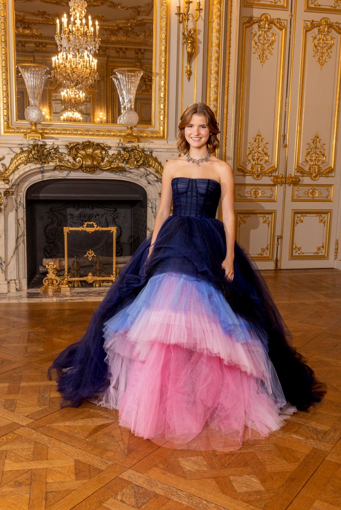 Young woman wearing navy and pink tulle gown